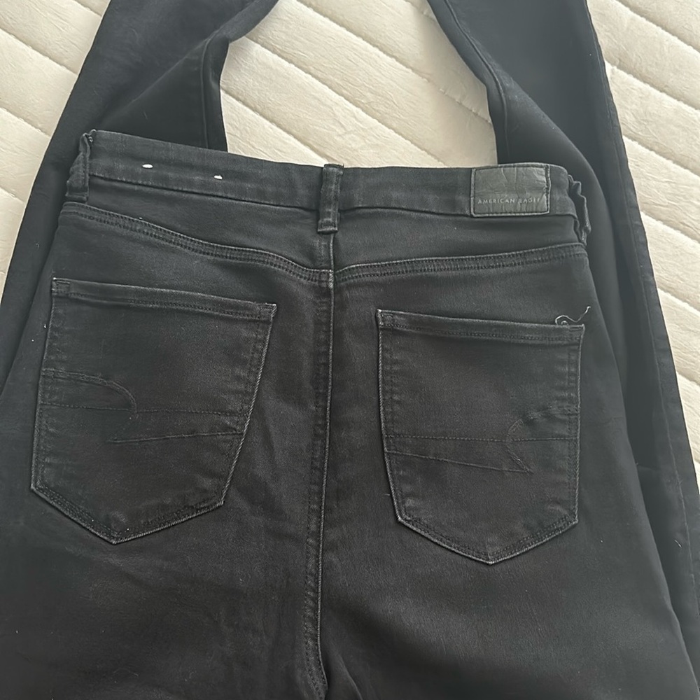 AE black next level stretch high rise Jean with holes in knees size 8